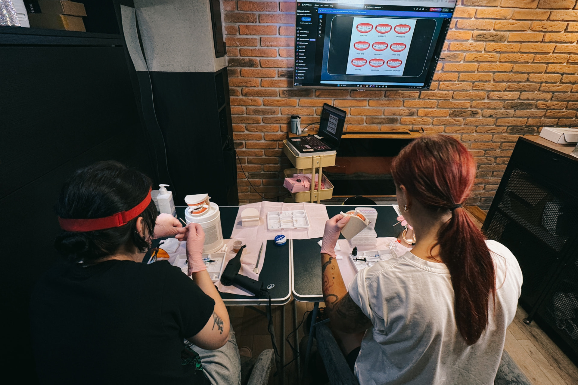 Students practicing tooth gem application in a classroom setting