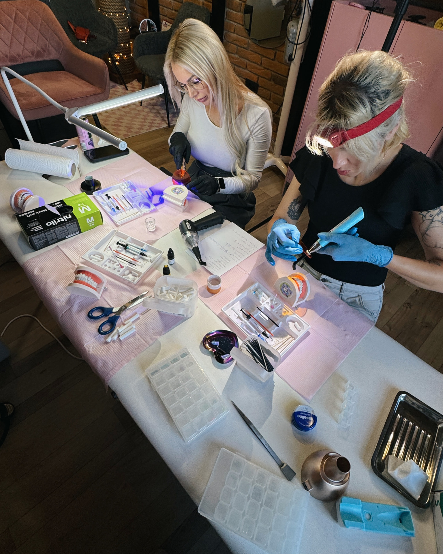 Students working with tooth gem practice tools and materials